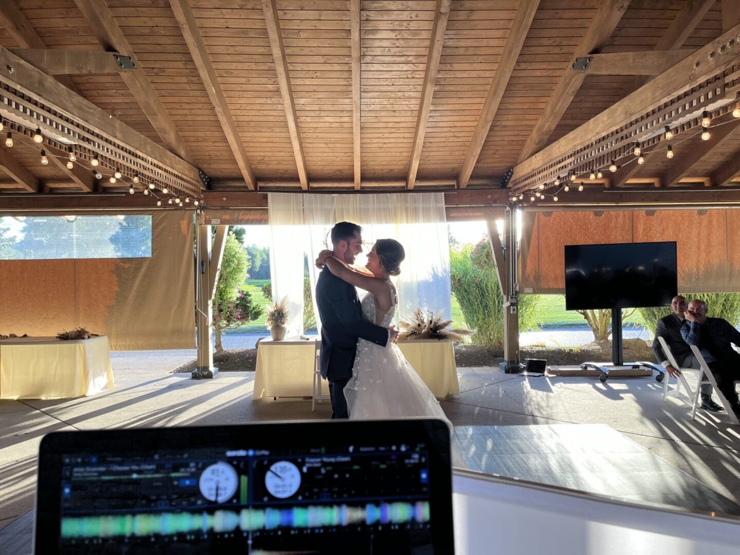 A couple is dancing in front of a tv.