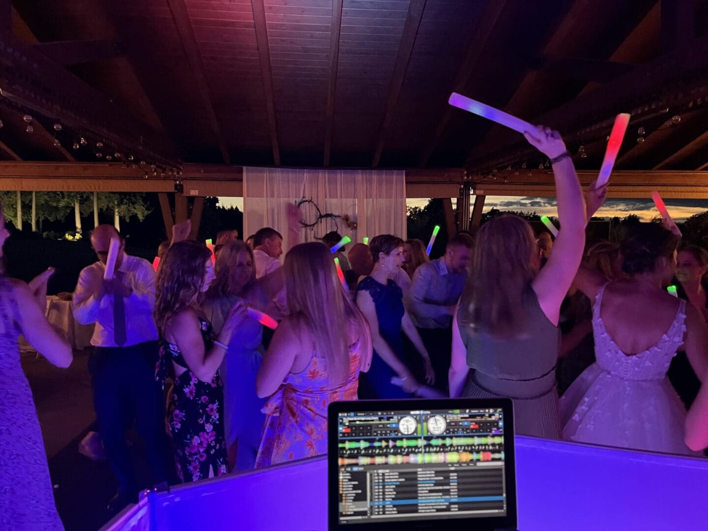 A group of people at a party with their hands in the air.